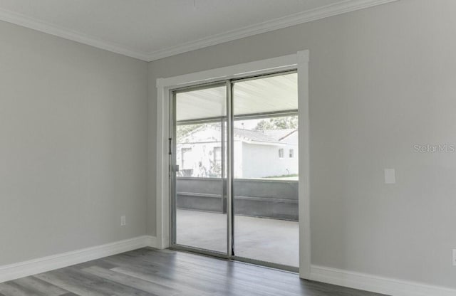 10859 William And Mary Ct, Orlando, FL 32821 - unfurnished room featuring baseboards, ornamental molding, and wood finished floors