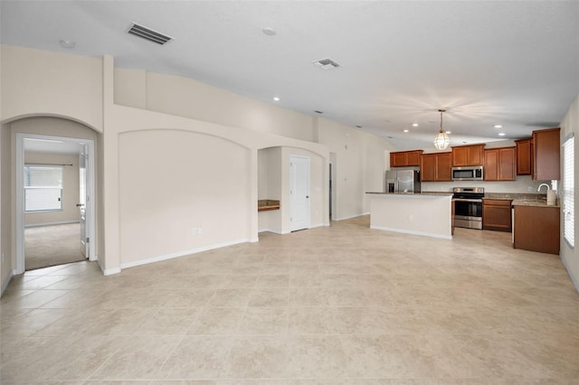 unfurnished living room featuring visible vents, recessed lighting, and a healthy amount of sunlight