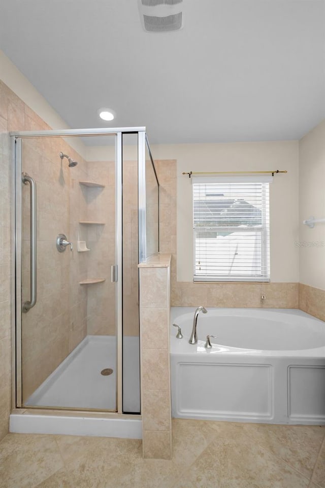 full bathroom featuring visible vents, a bath, and a stall shower