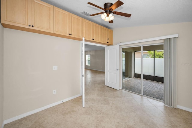unfurnished bedroom with baseboards, multiple windows, ceiling fan, and a closet