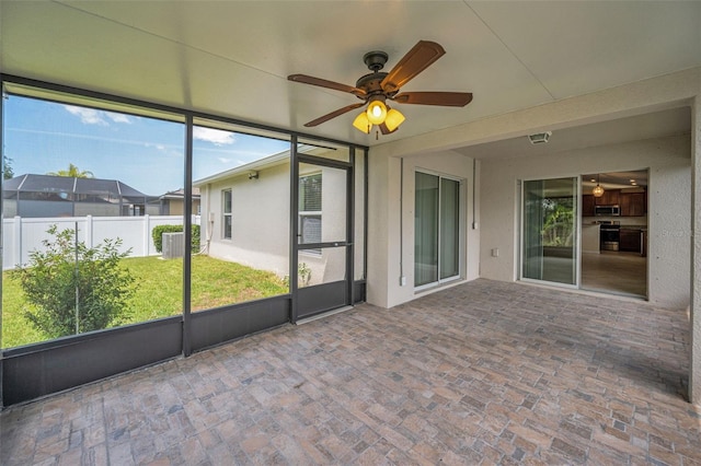 unfurnished sunroom featuring ceiling fan
