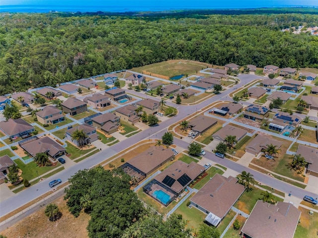 birds eye view of property featuring a forest view and a residential view