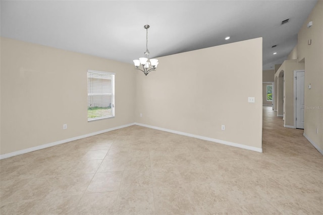 unfurnished room with baseboards, a notable chandelier, light tile patterned floors, and visible vents