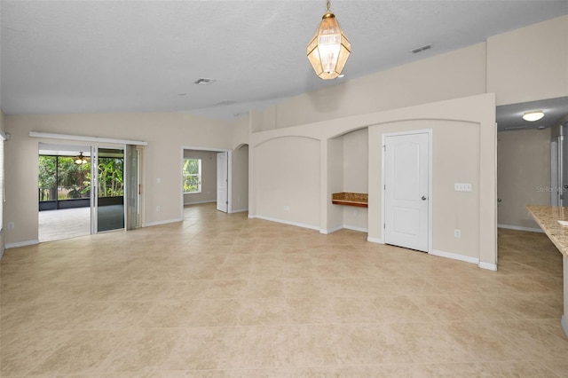 unfurnished living room featuring arched walkways, baseboards, light tile patterned floors, lofted ceiling, and visible vents