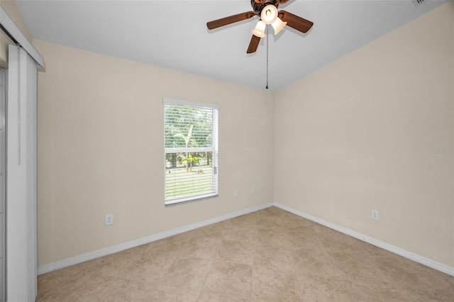 unfurnished room with baseboards and ceiling fan