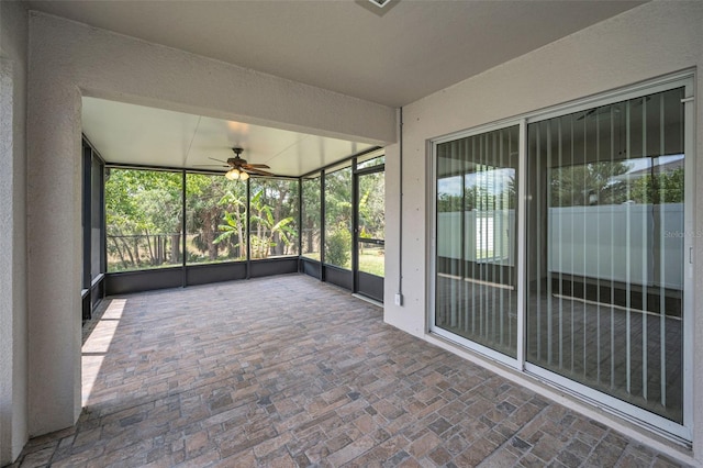 unfurnished sunroom with plenty of natural light and ceiling fan