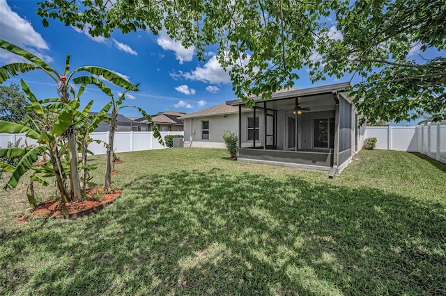 view of yard featuring a fenced backyard, a ceiling fan, a sunroom, and cooling unit