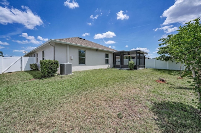 rear view of property featuring stucco siding, a sunroom, a fenced backyard, a gate, and central air condition unit