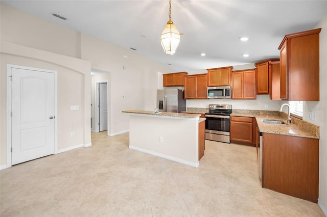 kitchen featuring a sink, brown cabinetry, stainless steel appliances, a kitchen island, and vaulted ceiling