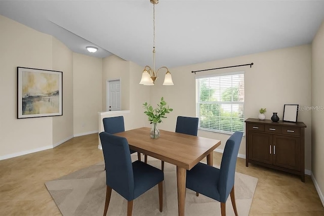 10106 Tolman Dr, Hudson, FL 34667 - dining area featuring lofted ceiling, baseboards, and a chandelier