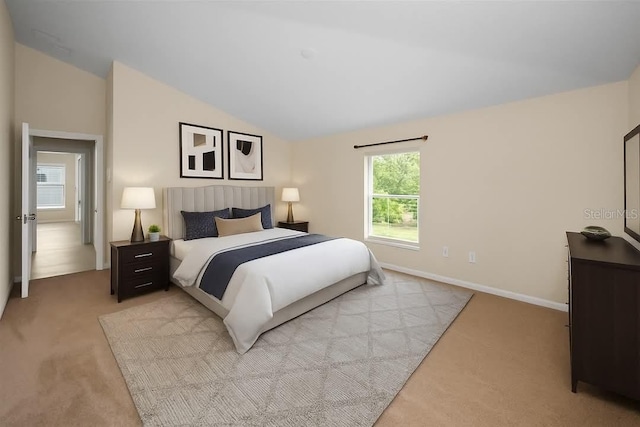 10106 Tolman Dr, Hudson, FL 34667 - bedroom featuring light colored carpet, lofted ceiling, and baseboards