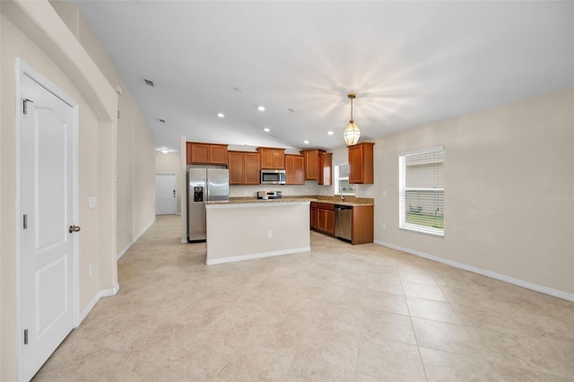 10106 Tolman Dr, Hudson, FL 34667 - kitchen with stainless steel appliances, a kitchen island, brown cabinets, light countertops, and pendant lighting