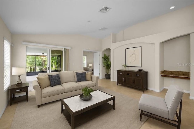 10106 Tolman Dr, Hudson, FL 34667 - living room featuring vaulted ceiling, light colored carpet, and baseboards
