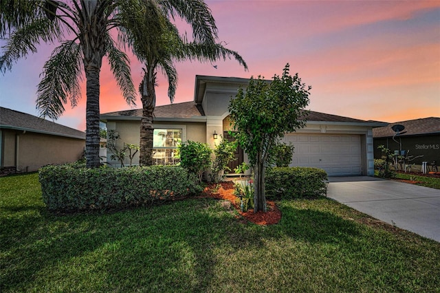 10106 Tolman Dr, Hudson, FL 34667 - view of front of home with an attached garage, driveway, stucco siding, and a front lawn