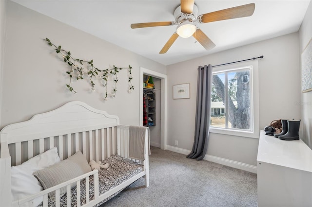 bedroom with a closet, carpet flooring, baseboards, and a ceiling fan