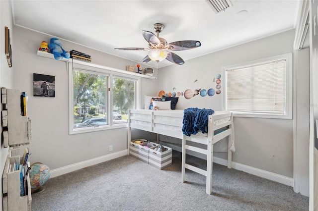 bedroom with carpet flooring, baseboards, visible vents, and ceiling fan