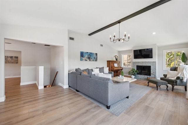 living room with an inviting chandelier, light wood-style flooring, baseboards, vaulted ceiling with beams, and visible vents
