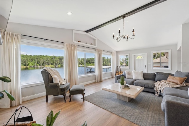 living room with vaulted ceiling with beams, light wood finished floors, and a chandelier