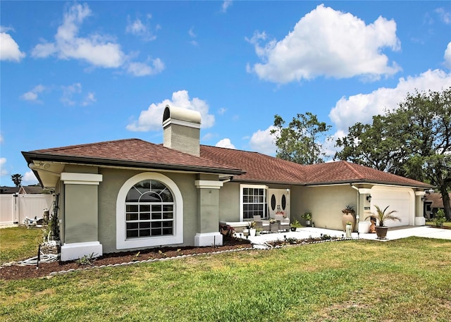 13373 Lawrence St, Spring Hill, FL 34609 - back of house featuring a lawn, a garage, a chimney, and stucco siding