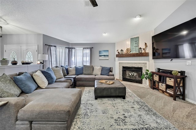 13373 Lawrence St, Spring Hill, FL 34609 - carpeted living room with visible vents, a fireplace with flush hearth, and a textured ceiling