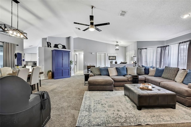 13373 Lawrence St, Spring Hill, FL 34609 - living area featuring a ceiling fan, light colored carpet, lofted ceiling, and visible vents