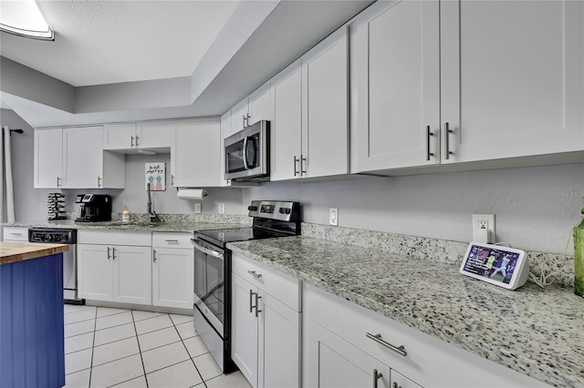 13373 Lawrence St, Spring Hill, FL 34609 - kitchen with appliances with stainless steel finishes, a sink, white cabinets, wood counters, and light tile patterned flooring