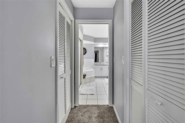 13373 Lawrence St, Spring Hill, FL 34609 - corridor featuring baseboards, light carpet, and light tile patterned floors