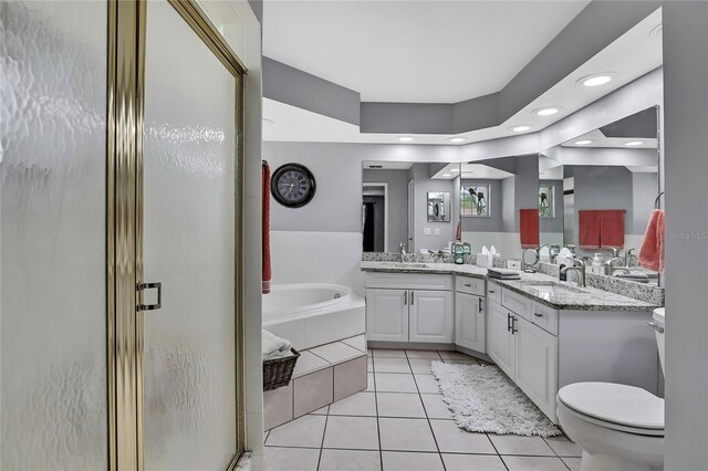 13373 Lawrence St, Spring Hill, FL 34609 - full bath with a sink, toilet, tile patterned floors, a bath, and a stall shower