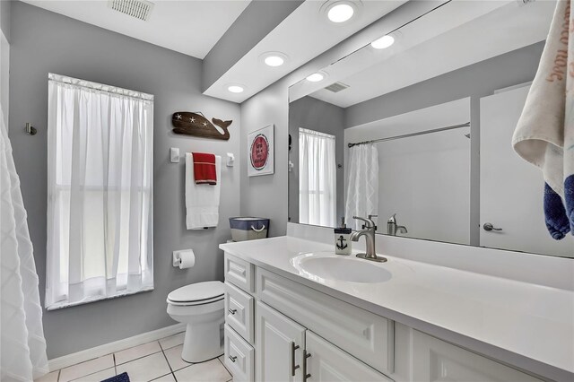 13373 Lawrence St, Spring Hill, FL 34609 - bathroom featuring visible vents, baseboards, tile patterned flooring, and toilet