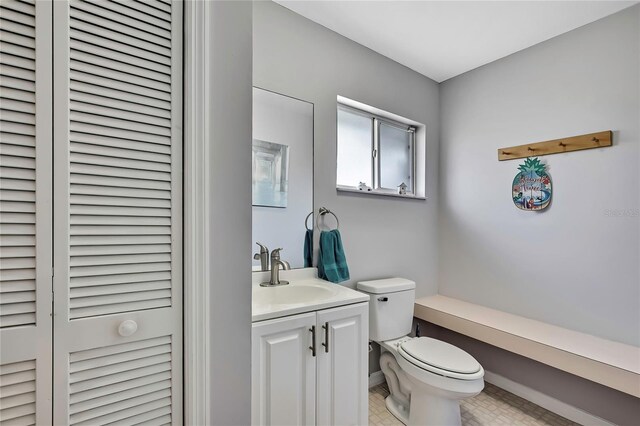 13373 Lawrence St, Spring Hill, FL 34609 - bathroom featuring vanity, baseboards, a closet, and toilet