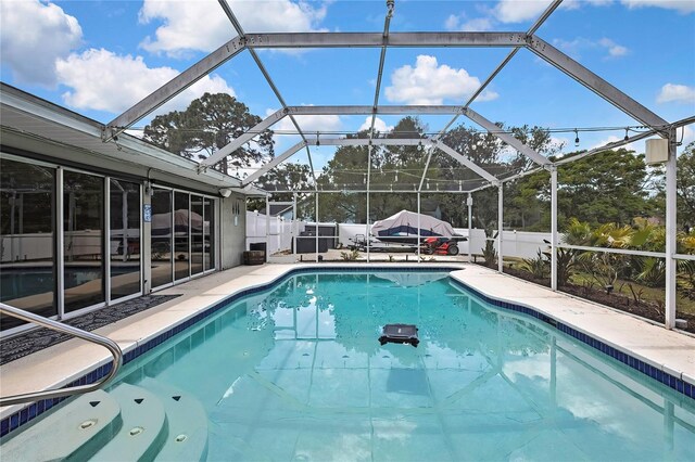 13373 Lawrence St, Spring Hill, FL 34609 - view of pool with glass enclosure, a fenced in pool, a fenced backyard, and a patio area