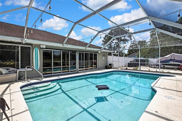13373 Lawrence St, Spring Hill, FL 34609 - view of pool featuring glass enclosure, fence, a fenced in pool, and a patio area