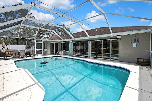 13373 Lawrence St, Spring Hill, FL 34609 - view of pool featuring glass enclosure, a patio, a fenced in pool, and fence