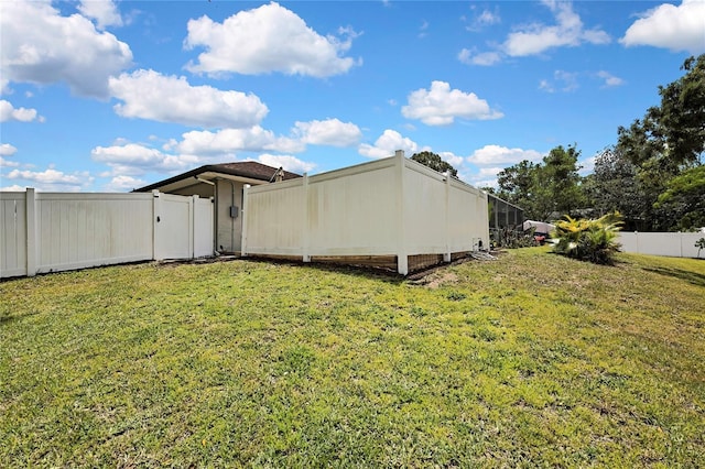 13373 Lawrence St, Spring Hill, FL 34609 - view of side of home with a lawn and a fenced backyard
