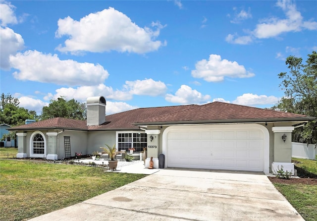 13373 Lawrence St, Spring Hill, FL 34609 - view of front facade with a chimney, a front yard, a garage, concrete driveway, and stucco siding