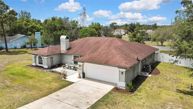 13373 Lawrence St, Spring Hill, FL 34609 - view of front of property featuring a front yard, fence, concrete driveway, an attached garage, and stucco siding