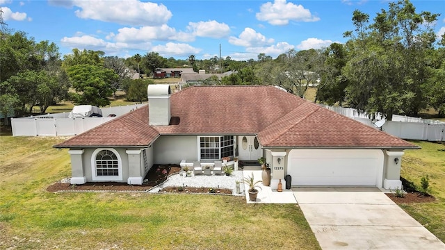 13373 Lawrence St, Spring Hill, FL 34609 - view of front of house featuring stucco siding, a front lawn, fence private yard, and a garage