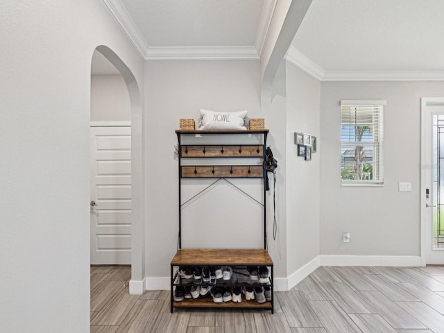 8630 Campus Woods Way, New Port Richey, FL 34655 - foyer entrance featuring baseboards, arched walkways, wood finish floors, and ornamental molding