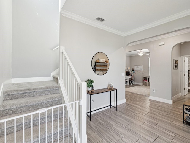 8630 Campus Woods Way, New Port Richey, FL 34655 - stairway with arched walkways, ornamental molding, a ceiling fan, and visible vents