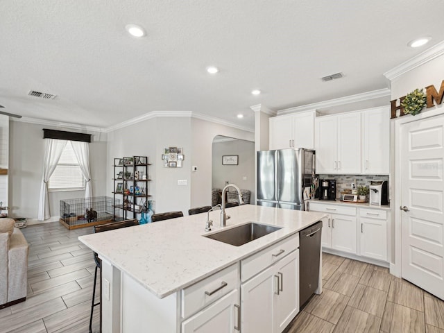 8630 Campus Woods Way, New Port Richey, FL 34655 - kitchen featuring a sink, visible vents, stainless steel appliances, and open floor plan