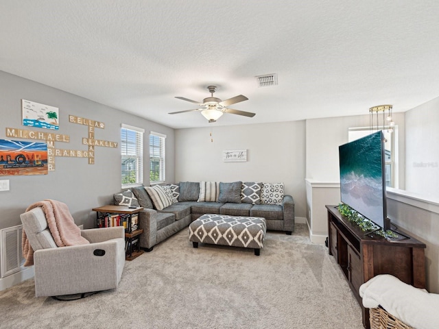 8630 Campus Woods Way, New Port Richey, FL 34655 - carpeted living room with a textured ceiling, ceiling fan, and visible vents