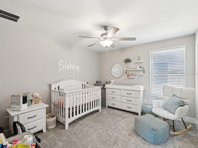 8630 Campus Woods Way, New Port Richey, FL 34655 - bedroom with light colored carpet, a ceiling fan, and visible vents
