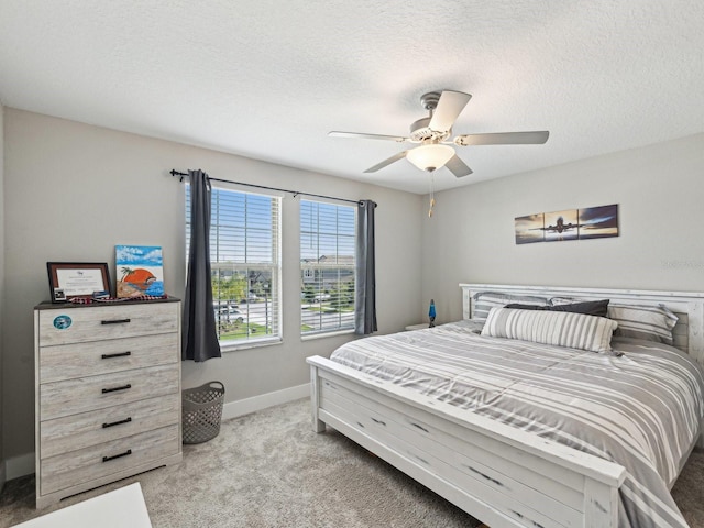 8630 Campus Woods Way, New Port Richey, FL 34655 - bedroom featuring a ceiling fan, baseboards, light carpet, and a textured ceiling