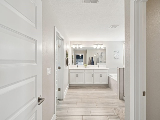 8630 Campus Woods Way, New Port Richey, FL 34655 - full bath with double vanity, visible vents, a sink, and a bath