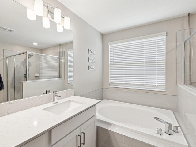 8630 Campus Woods Way, New Port Richey, FL 34655 - full bath with visible vents, vanity, a wealth of natural light, and a shower stall