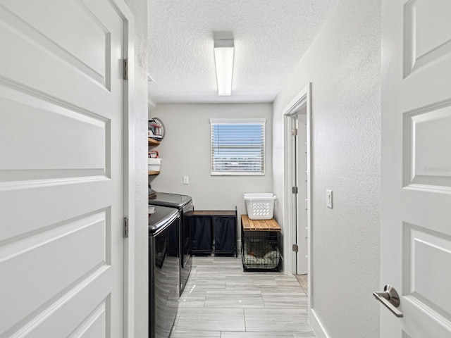 8630 Campus Woods Way, New Port Richey, FL 34655 - washroom with laundry area, a textured wall, washer and dryer, baseboards, and a textured ceiling