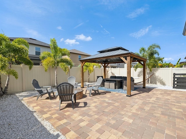 8630 Campus Woods Way, New Port Richey, FL 34655 - view of patio / terrace featuring a gazebo, a fenced backyard, and an outdoor living space with a fire pit