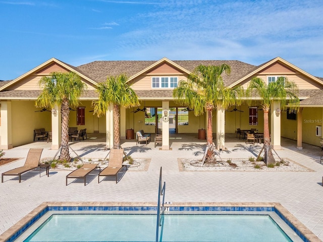 8630 Campus Woods Way, New Port Richey, FL 34655 - rear view of property with a shingled roof, ceiling fan, and a patio area