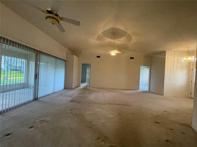 interior space with light colored carpet, vaulted ceiling, and ceiling fan with notable chandelier