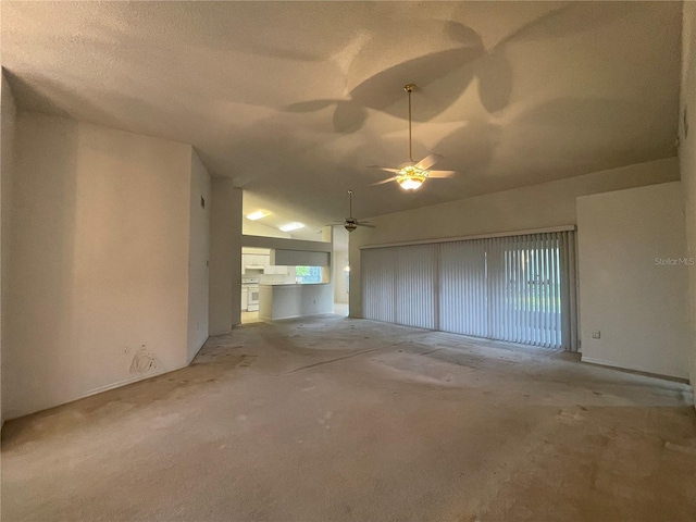 unfurnished living room featuring lofted ceiling and a ceiling fan